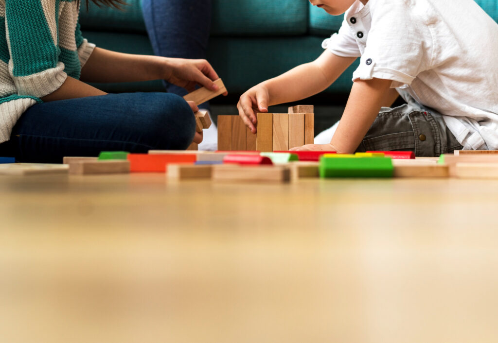 Child and therapist playing with toys