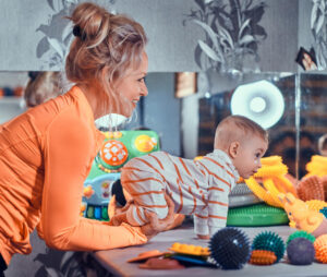 occupational therapist working with child with sensory treatment toys