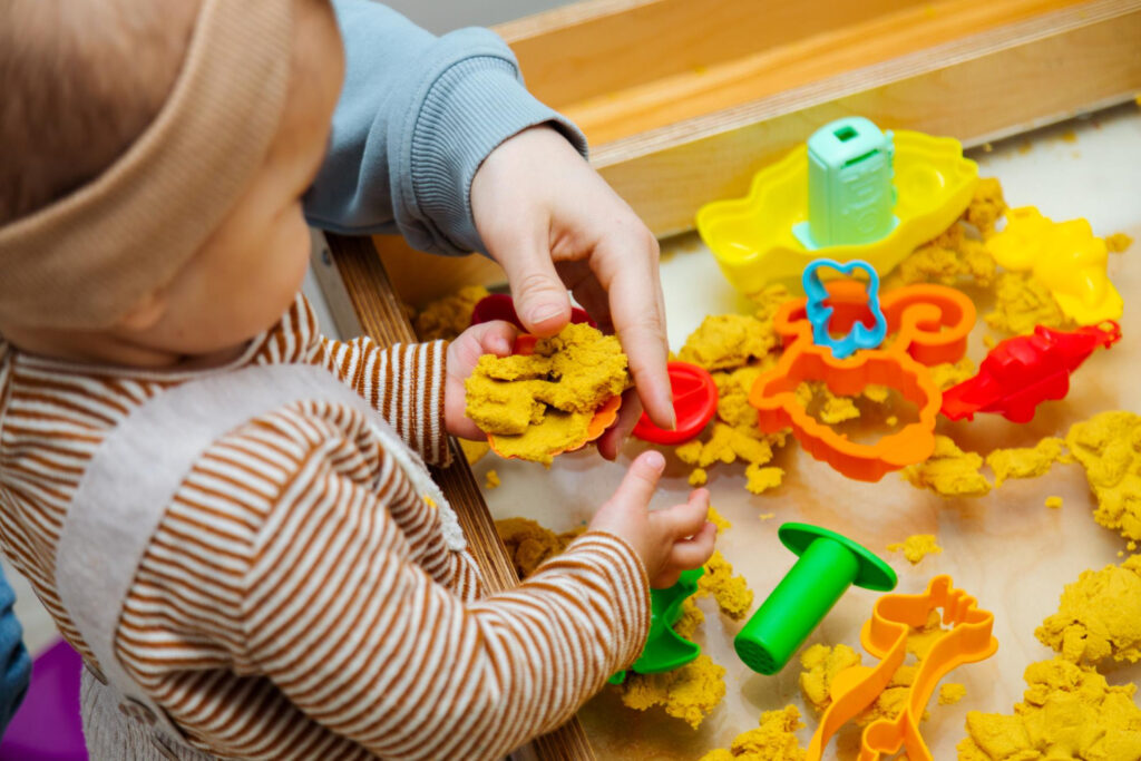 Child with Sensory Processing Disorder playing with kinetic sand