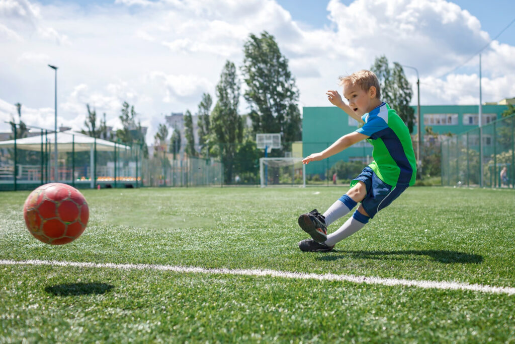 Child crossing the midline by playing soccer