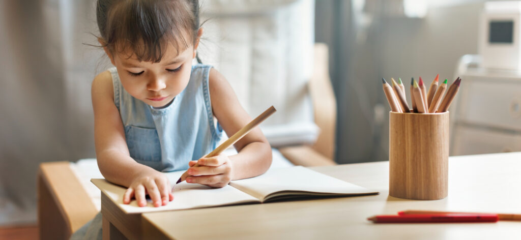 Child writing on paper